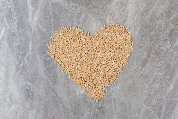 Uncooked oat grains on marble surface