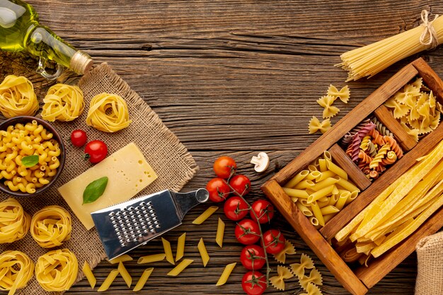 Uncooked pasta mix with tomatoes olive oil and hard cheese