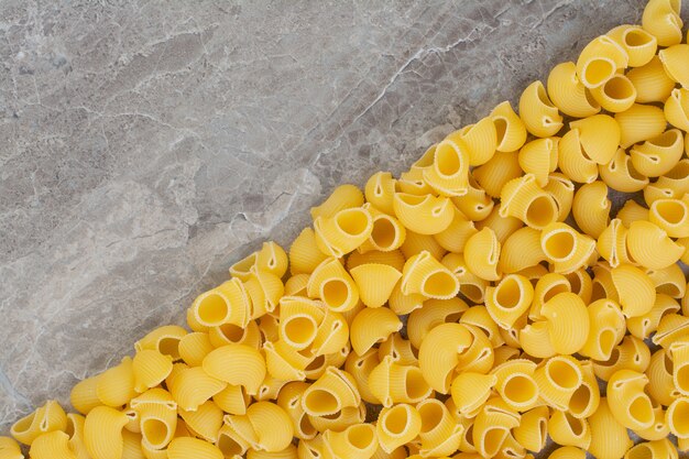 Uncooked pastas isolated on the marble space. 