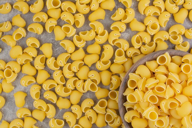 Uncooked pastas isolated on the marble space. 