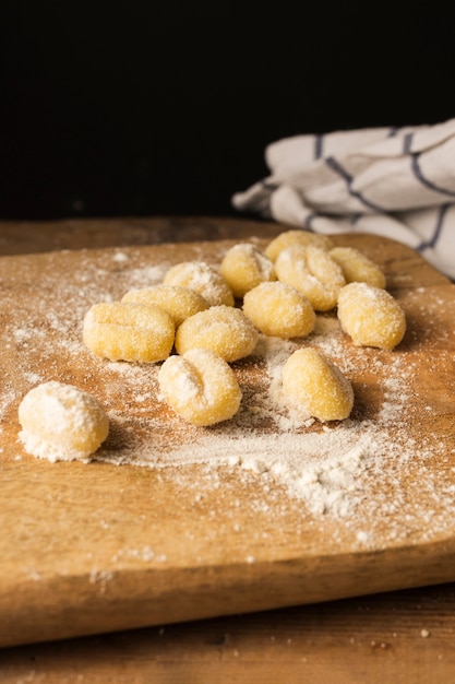Uncooked potato gnocchi on cutting board