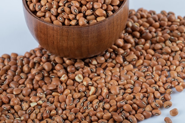 Uncooked red beans in wooden bowl.