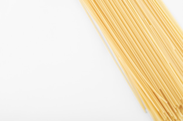 Uncooked spaghetti pasta on white background. High quality photo