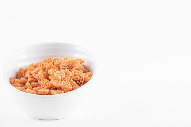 Uncooked spaghetti pasta on white.
