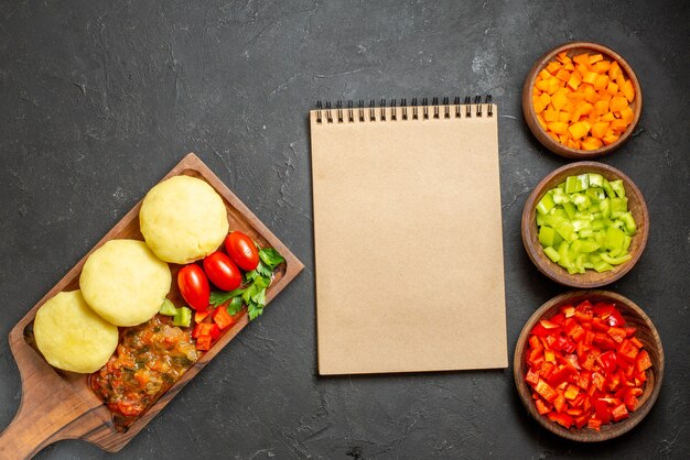 Uncooked vegetables on a brown cutting board