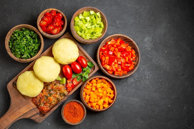 Uncooked vegetables on a brown cutting board