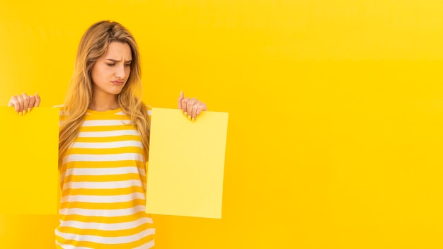 Undecided woman holding papers