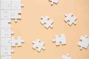 Free photo unfinished white jigsaw