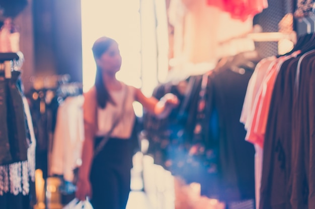 Unfocused background with woman in a clothing store