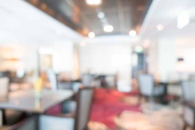 Unfocused restaurant with dark wooden chairs