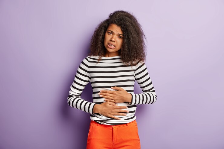 Free Photo unhappy afro american woman touches belly, suffers from menstrual period cramp