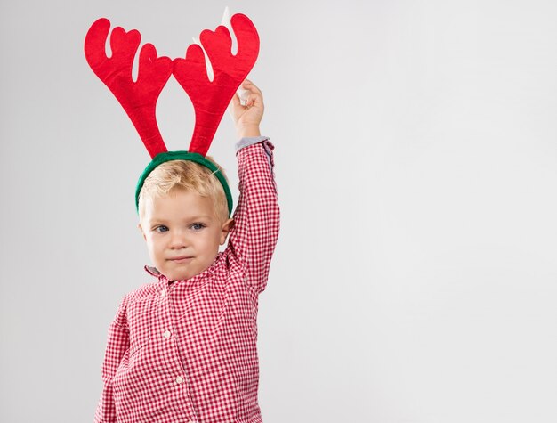 Unhappy boy with reindeer antlers