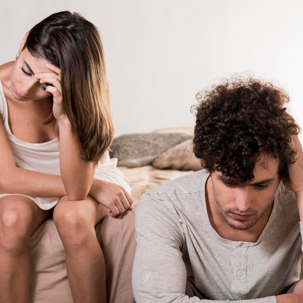 Unhappy couple in bedroom