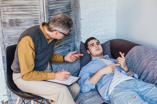 Free photo unhappy male patient listening to a psychologist counselor advice