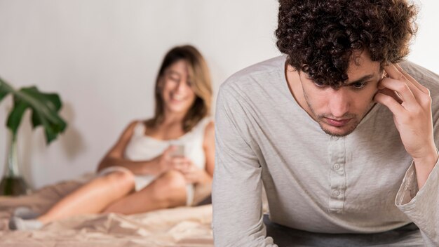 Unhappy man in bedroom