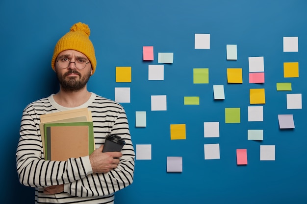 Unhappy schoolboy spends free time on language learning, tries to remember new words with help of sticky notes