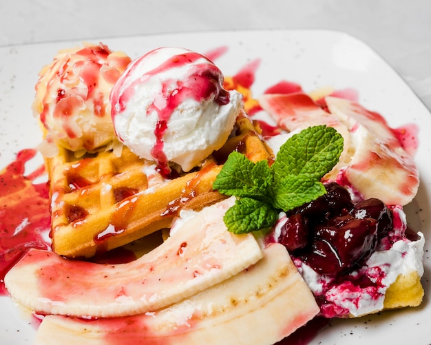 Unhealthy waffles with bananas close up