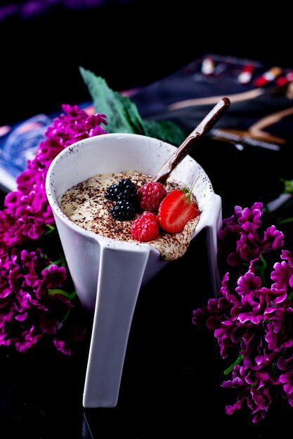 A unique cup of vanilla pudding with coffee sprinkles and berries