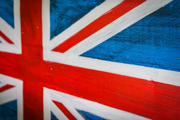 United Kingdom flag painted on aged wooden wall .