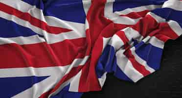 Free photo united kingdom flag wrinkled on dark background 3d render