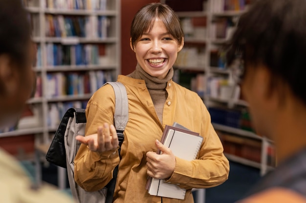 University colleagues talking in the library