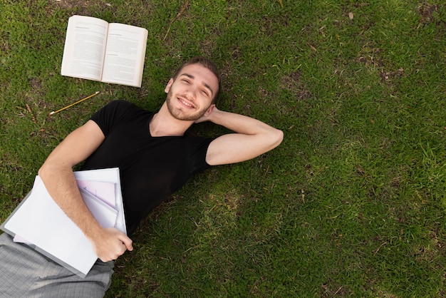 University student taking a break on grass