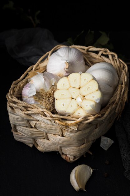 Unpeeled organic garlics in basket