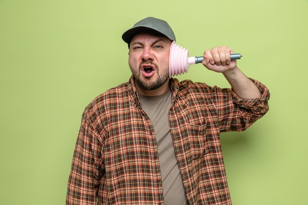 Unpleased slavic cleaner man covering his ear with rubber plunger 