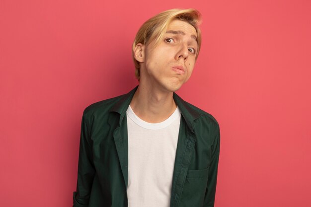 Unpleased young blonde guy wearing green t-shirt