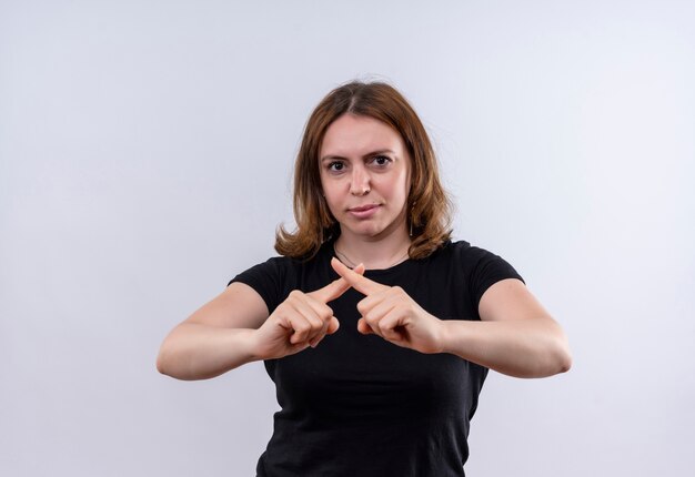 Unpleased young casual woman gesturing no on isolated white wall with copy space