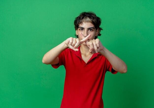 Unpleased young caucasian girl with pixie haircut doing no gesture isolated on green background with copy space