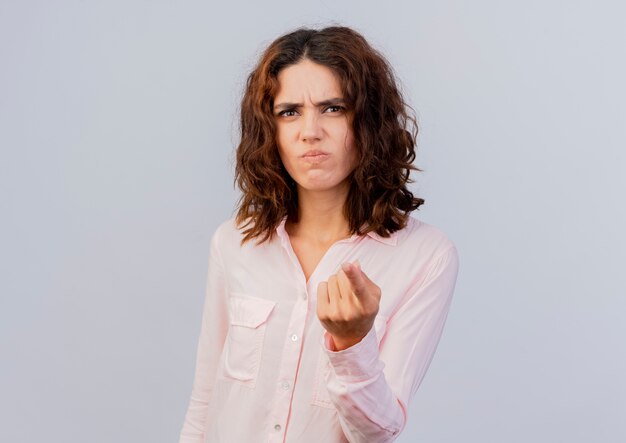 Unpleased young caucasian woman points at camera