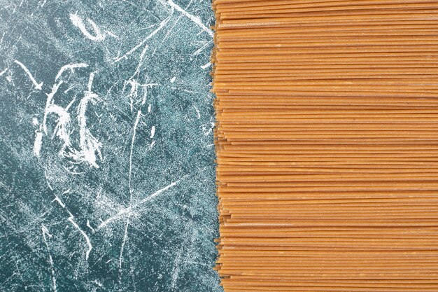 Unprepared fresh pasta on marble background. High quality photo