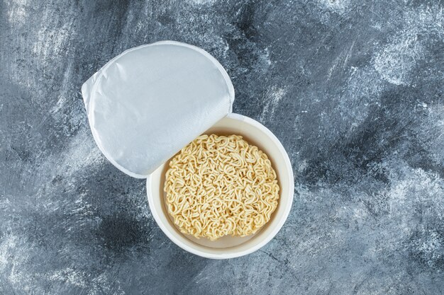 Unprepared noodles on a dark surface.