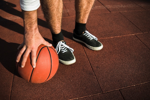 Unrecognisable athlete grabbing basketball