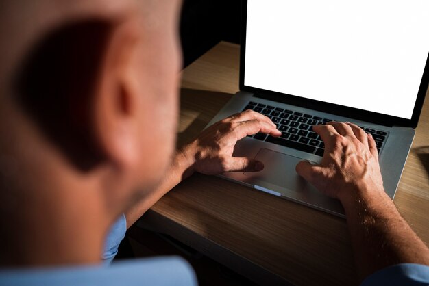 Unrecognisable casual man typing on laptop