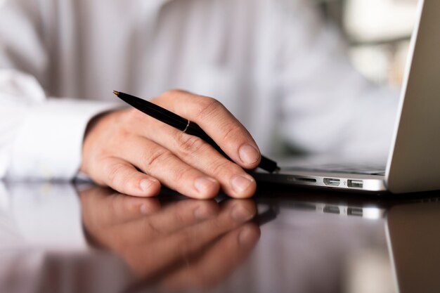 Unrecognisable employee holding pen close up