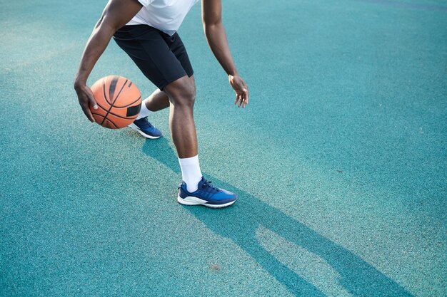 Premium Photo | Muscular african-american man throwing basketball ball