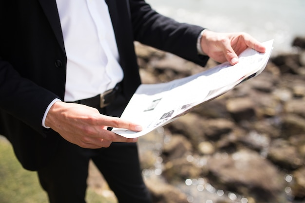 Unrecognizable businessman using pocket map