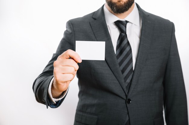 Unrecognizable businessman with card