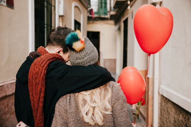 Unrecognizable couple with balloons