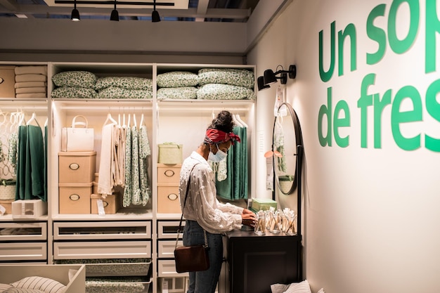 Free photo unrecognizable female black customer choosing goods in shopping mall