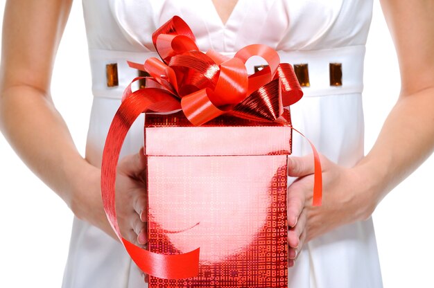 Unrecognizable female person holding the red  gift box - isolated on  white