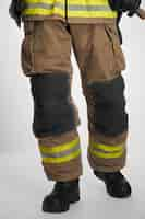 Free photo unrecognizable firefighter walking after hard working day crop view of fireman in uniform and black