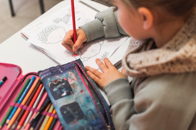 Unrecognizable kid coloring picture