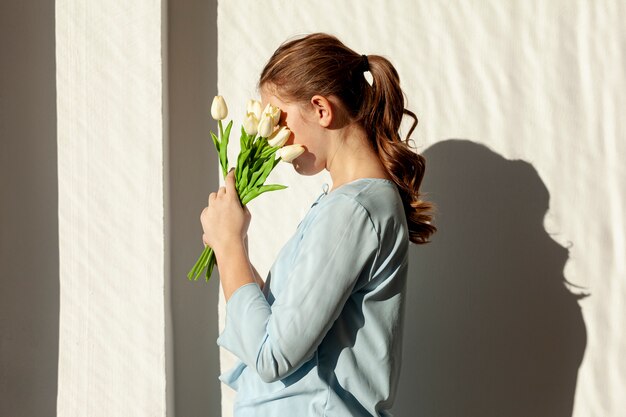 Unrecognizable lady holding white tulips