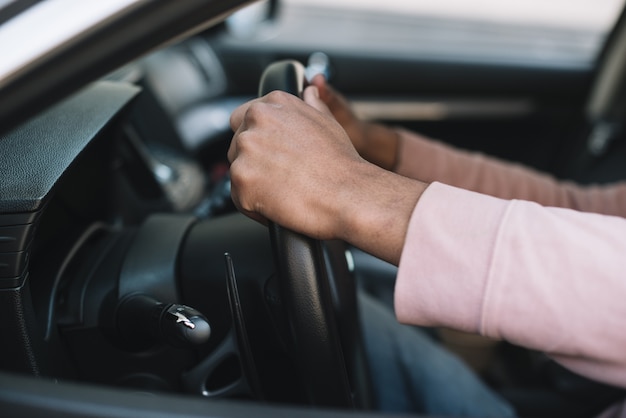 Unrecognizable man driving close up