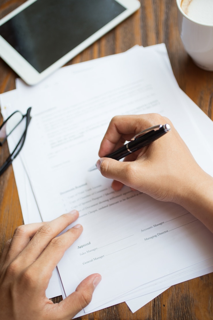 Free Photo unrecognizable man filling application form