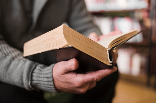 Free photo unrecognizable man holding book close up