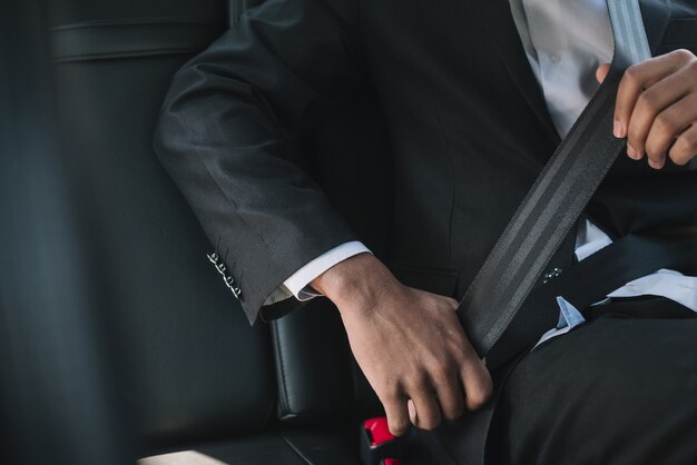 Unrecognizable man wearing seatbelt